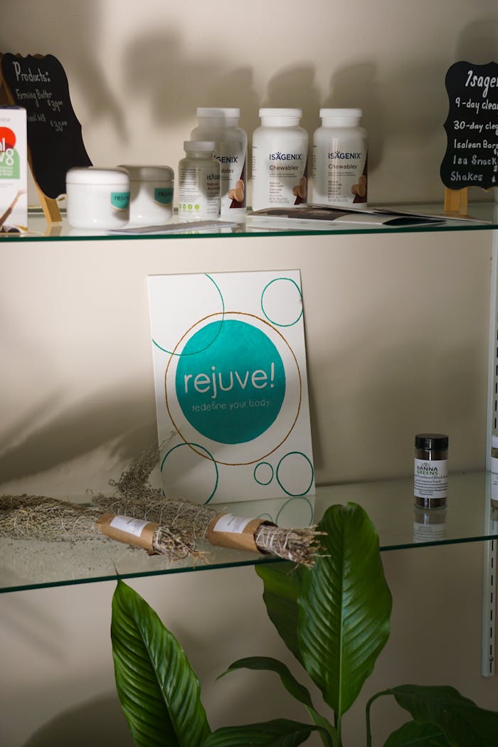 A variety of wellness products and supplements showcased on a modern glass shelf for rejuvenation.